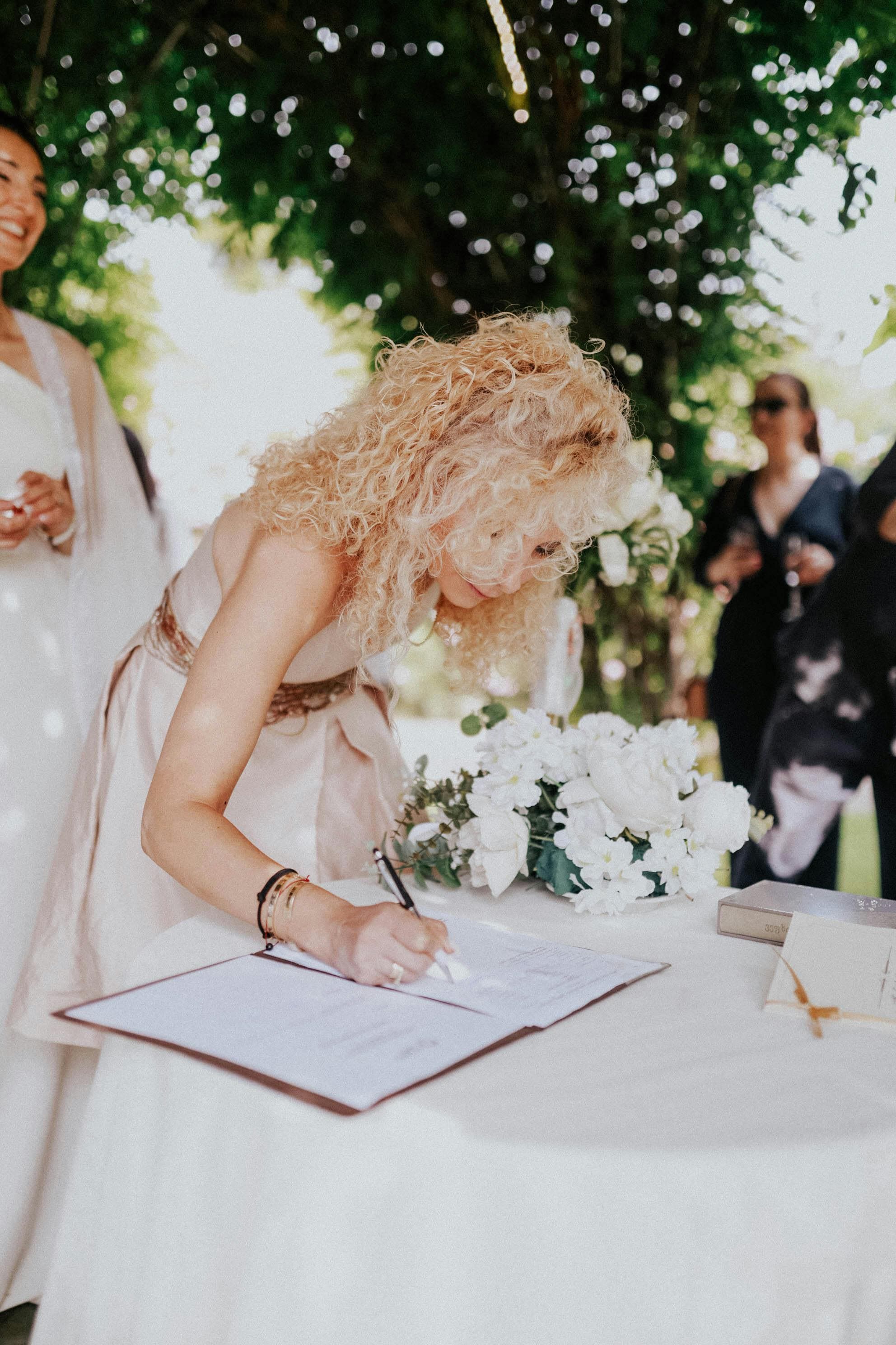 Couple signing legal wedding documents at their Cyprus ceremony